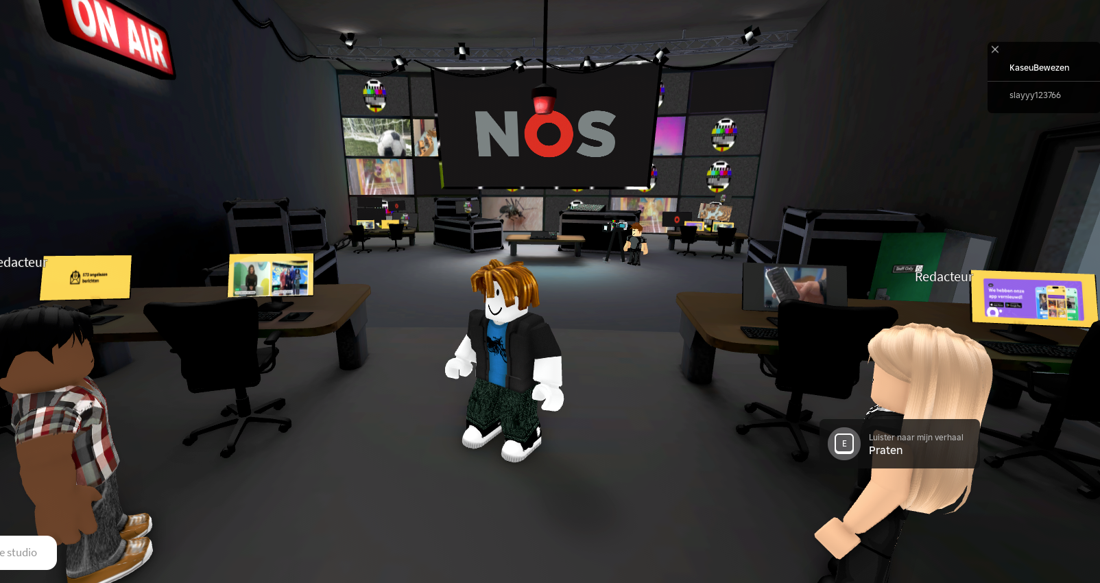 Virtual newsroom environment with avatars standing among desks and screens, with a large NOS logo displayed on a central studio screen.”